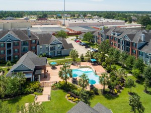 Apartments Rentals in Conroe, TX - Aerial View of Community, Pool & Surrounding Area      